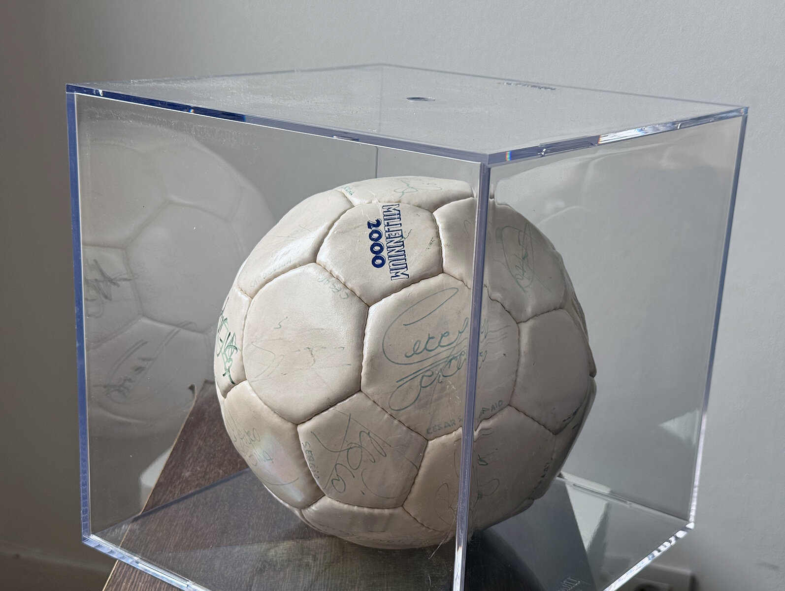 The signed football in a display case.