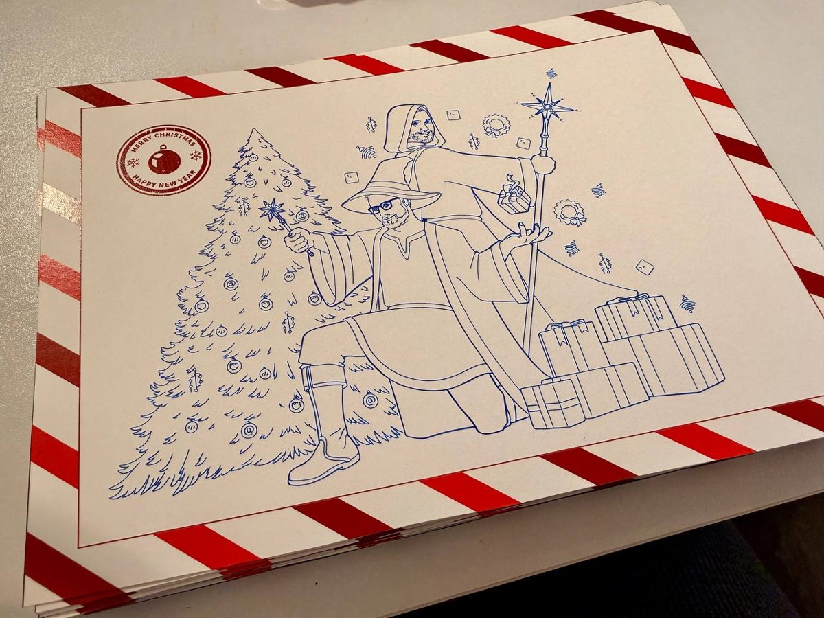The back of a Christmas card: a wizard illustration next to a Christmas tree, drawn by the plotter in blue ink.