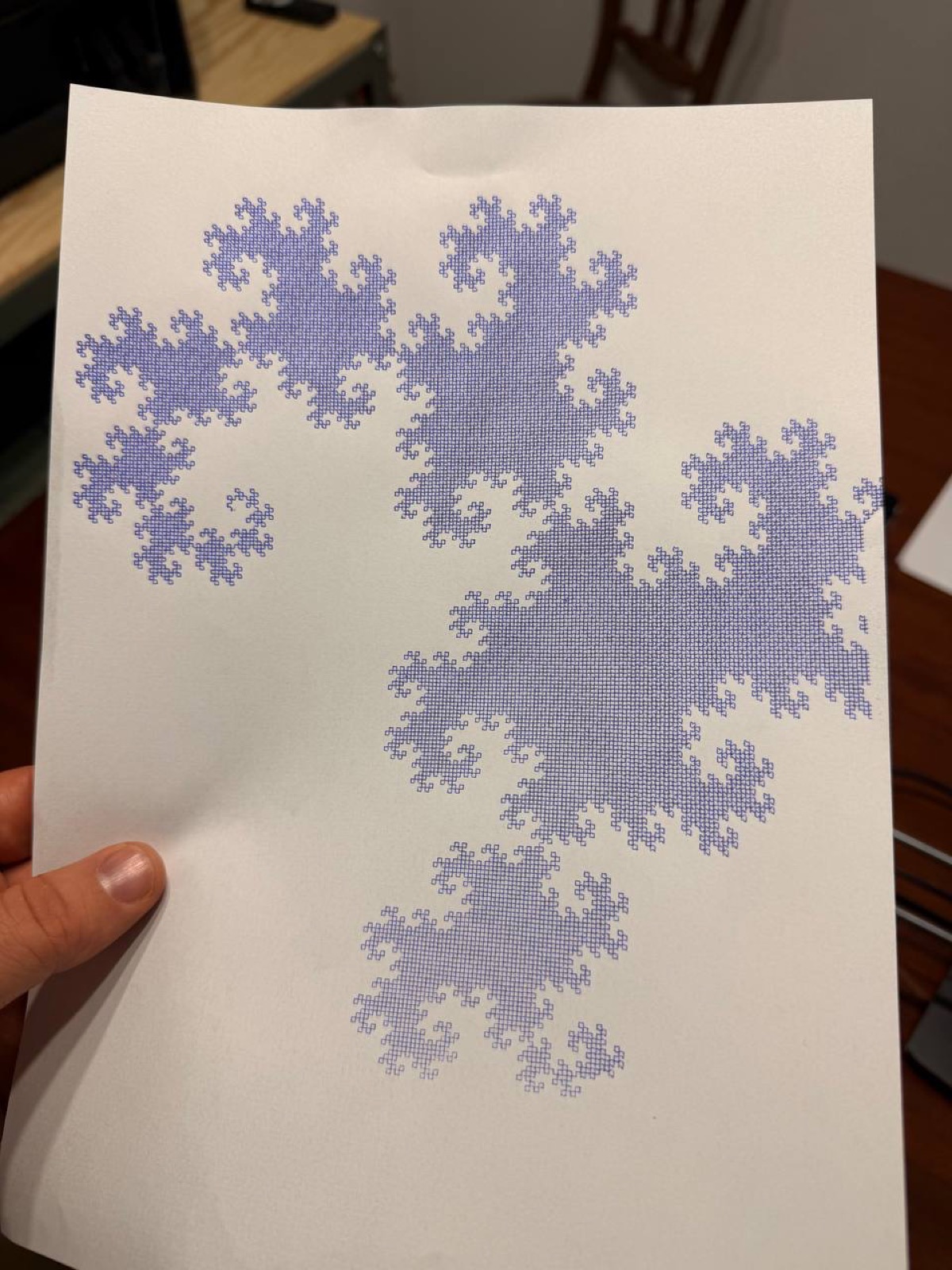 Dragon curve fractal plotted in blue ink, showing the intricate self-similar pattern.
