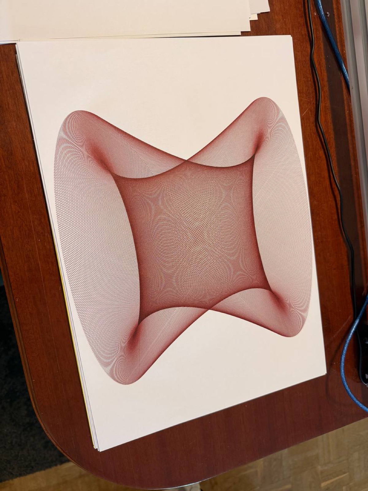 Guilloche pattern in red ink, the kind of intricate overlapping curves you see on banknotes.