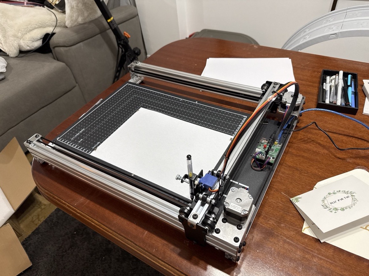 The iDraw H SE A3 plotter on a desk, with the Raspberry Pi connected and a sheet of paper ready to go.